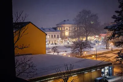a city at night with snow on the ground at Muki Park Lake in Tuzla