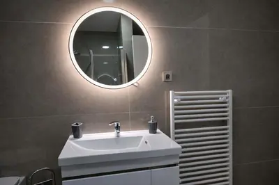 a bathroom with a white sink and a mirror at Muki Park Lake in Tuzla