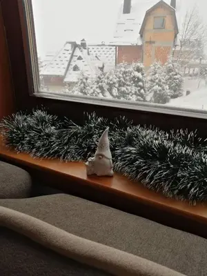 a window sill with a santa claus figurine on it at Apartmani 