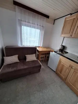 a small living room with a couch and a table at Apartmani 