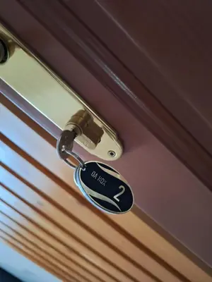 a key to a door with a keychain on it at Apartmani 