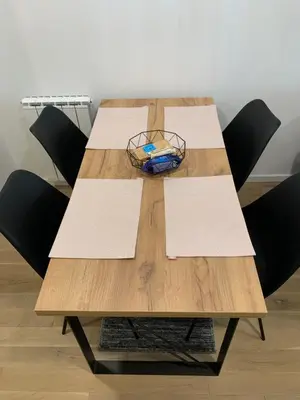 a wooden table with chairs and a bowl on it at Park Lake Suite in Tuzla