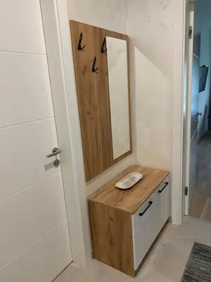 a bathroom with a sink and a mirror at Park Lake Suite in Tuzla