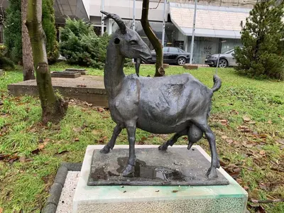 a statue of a goat standing on a pedestal at Park Lake Suite in Tuzla