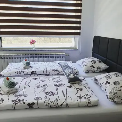 two beds with pillows on them in a bedroom at Apartments Arna in Visoko