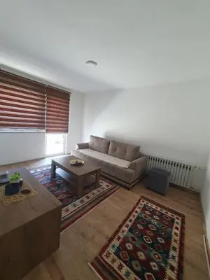 a living room with a couch and a coffee table at Apartments Arna in Visoko