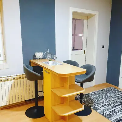 a yellow table and chairs in a room at Apartments Arna in Visoko