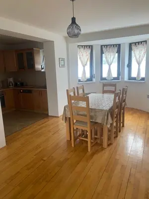 a kitchen and dining room with a table and chairs at Kuća za odmor Ivana in Kupres
