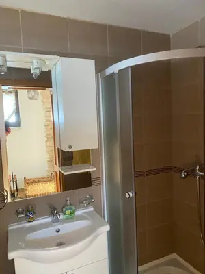 a bathroom with a sink and a shower at Kuća za odmor Ivana in Kupres