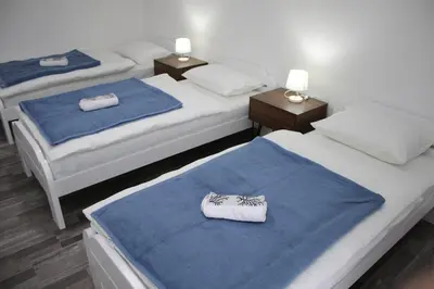 two beds in a room with blue and white at Vikendica Bošnjak in Prozor