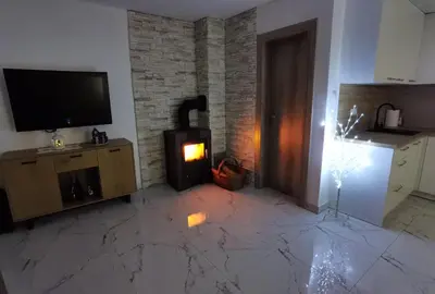 a living room with a television and a fireplace at Vikendica Bošnjak in Prozor