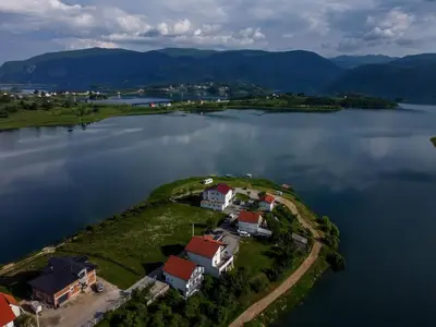 an island in the middle of a large body of water at Vikendica Bošnjak in Prozor