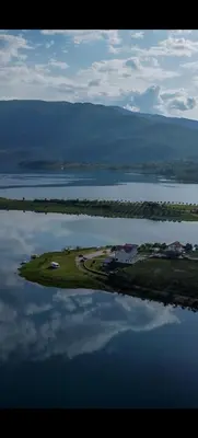 an island in the middle of a large body of water at Vikendica Bošnjak in Prozor