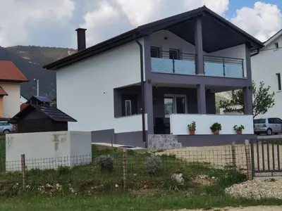 a white house with a black roof at Vikendica Bošnjak in Prozor