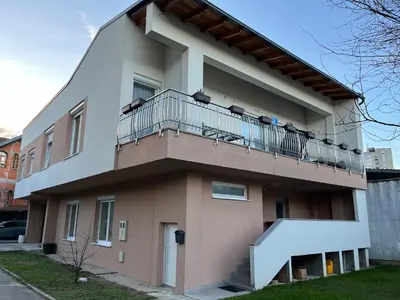 a building with a balcony on top of it at Apartman House Jasmina in Bihać