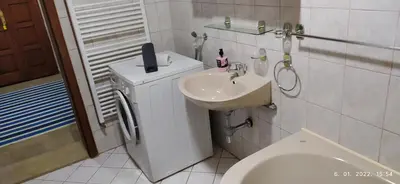 a white bathroom with a sink and a toilet at Apartman House Jasmina in Bihać