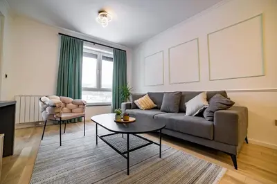 a living room with a couch and a table at Apartman EpiLux in Tuzla