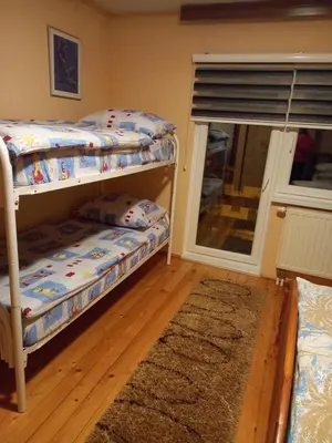 a bedroom with two bunk beds and a window at Apartman Suzana in Kupres