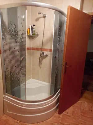 a shower with a glass door in a bathroom at Apartman Suzana in Kupres