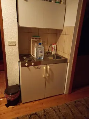 a small kitchen with a sink and a stove at Apartman Suzana in Kupres