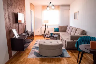 a living room with a couch and a table at Apartman Royal 3 in Doboj