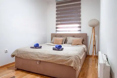a bedroom with a bed with two teddy bears on it at Apartman Royal 3 in Doboj