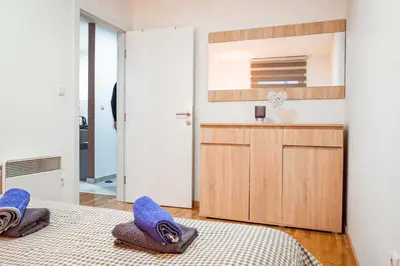 a bedroom with two beds with blue pillows at Apartman Royal 3 in Doboj