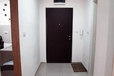 a black door in a room with a tile floor at Apartman Royal 3 in Doboj
