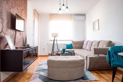 a living room with a couch and a table at Apartman Royal 3 in Doboj