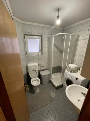 a bathroom with a toilet and a shower and a sink at Apartman Antonia in Kupres