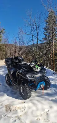 a black atv parked in the snow at Apartman Antonia in Kupres