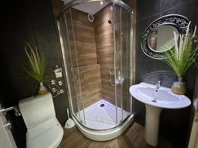 a bathroom with a shower and a toilet and a sink at Business Hotel Prijedor in Prijedor