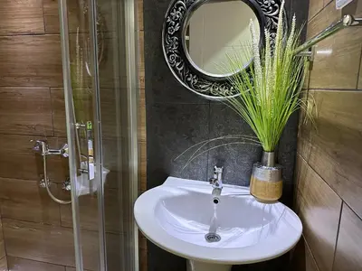 a bathroom with a sink and a mirror at Business Hotel Prijedor in Prijedor