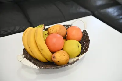 a bowl of fruit sitting on a table at Apartman Giljen in Teslić