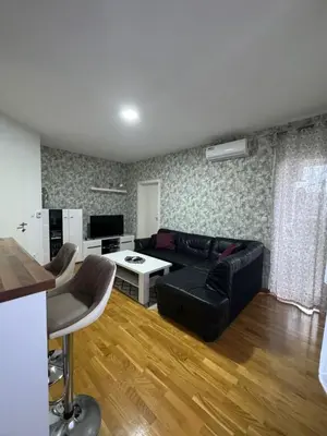 a living room with a couch and a table at Apartman Giljen in Teslić