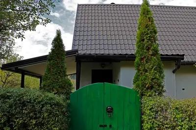 a green door in front of a house at Holiday Home Ravne in Visoko