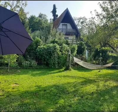 a hammock in a yard next to a house at Holiday Home Ravne in Visoko