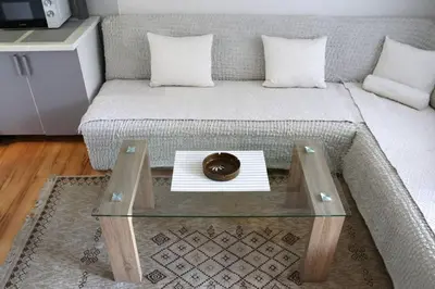 a living room with a couch with a coffee table at Holiday Home Ravne in Visoko