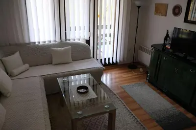 a living room with a couch and a coffee table at Holiday Home Ravne in Visoko
