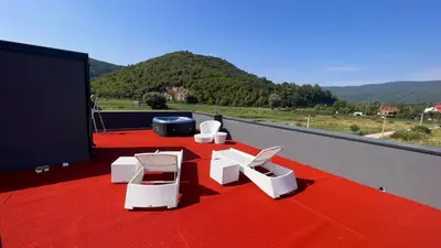 a room with white chairs on a red carpet at Lohovo Villa Bukva in Otoka