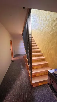 a staircase in a room with wooden steps and a wall at Lohovo Villa Bukva in Otoka