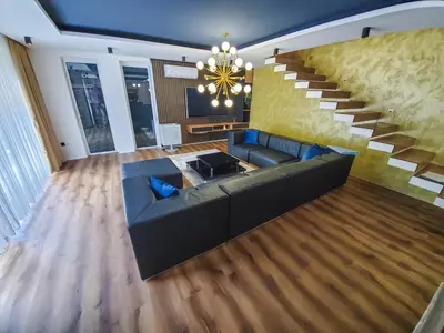 a living room with a couch and a staircase at Lohovo Villa Bukva in Otoka