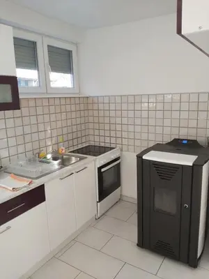 a small kitchen with a sink and a stove at Apartman Aladin in Bihać