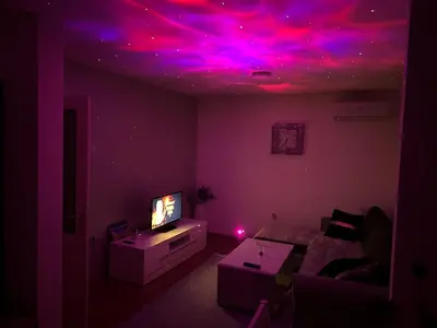 a living room with purple and pink lights on the ceiling at Apartman/Stan na dan Teslić in Teslić