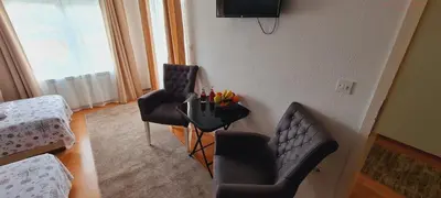 a living room with two chairs and a table at VISOKO Room in Visoko