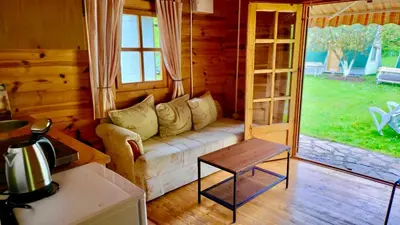 a living room with a couch and a table at Una Kamp in Bosanska Krupa