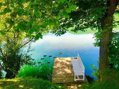 a bench sitting on top of a dock on a lake at Una Kamp in Bosanska Krupa