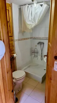 a bathroom with a toilet and a bath tub at Una Kamp in Bosanska Krupa