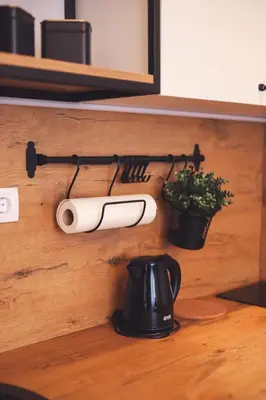 a wall with a paper towel holder and a plant at Central Square Apartment in Banja Luka