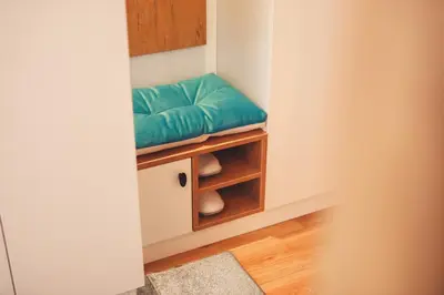a small room with a green pillow on a shelf at Central Square Apartment in Banja Luka